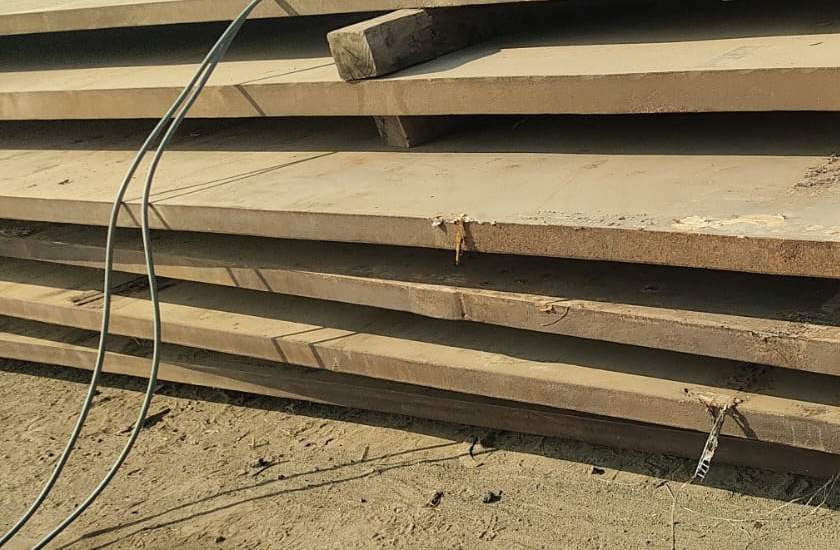 Stack of full-length 75 mm alloy steel clad plates, P22 chrome-moly with SS 410 cladding, at the J.S. STEEL yard, Bhavnagar