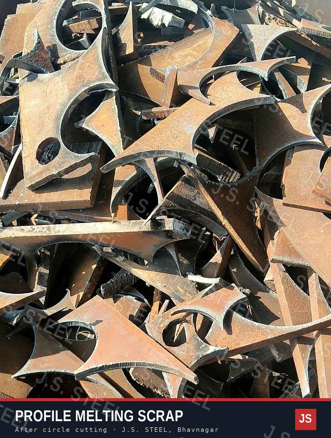 Close view of MS profile melting scrap: curved plate skeletons and offcuts left after circle cutting at the J.S. STEEL yard