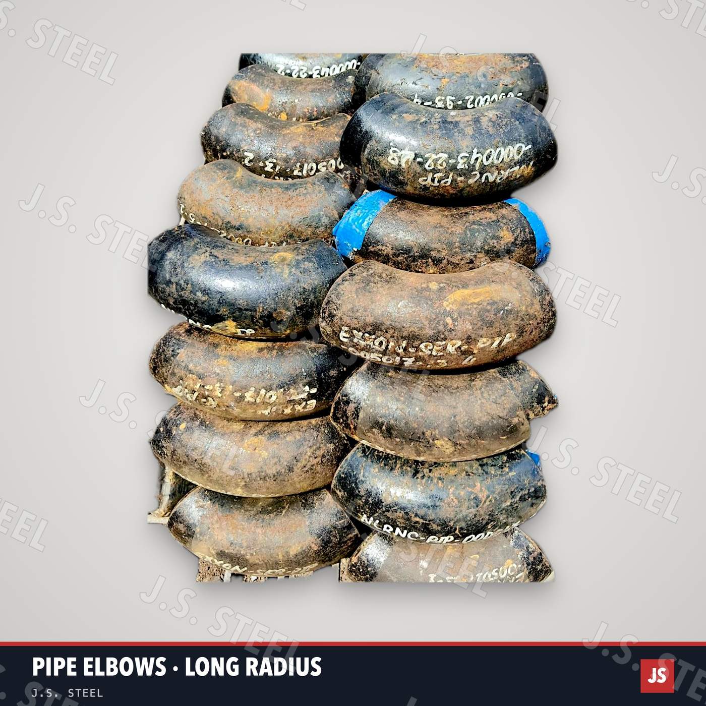 Stack of used long-radius steel pipe elbows with painted piece marks, ex-ship